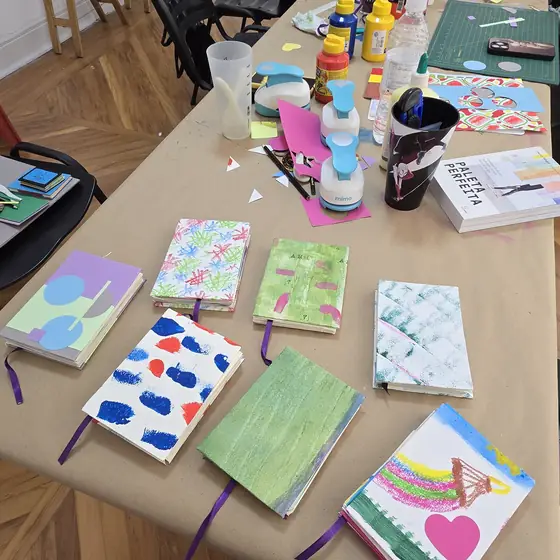 Cadernos artesanais com capas pintadas à mão, feitos pelas alunas na primeira oficina